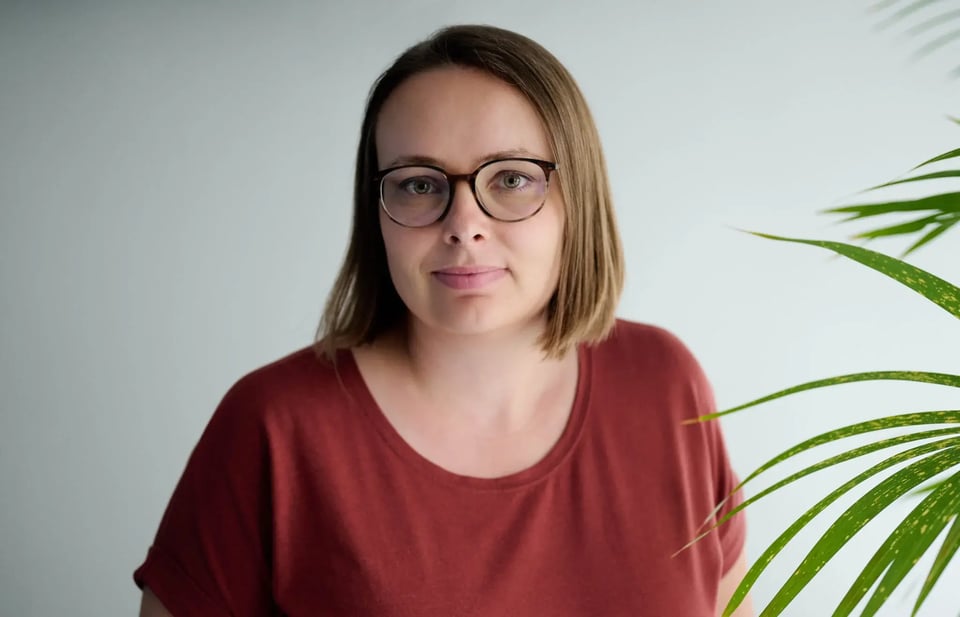 Professional headshot of Andrea Henrich, a consultant at Pharmetheus, smiling against a neutral gray background.