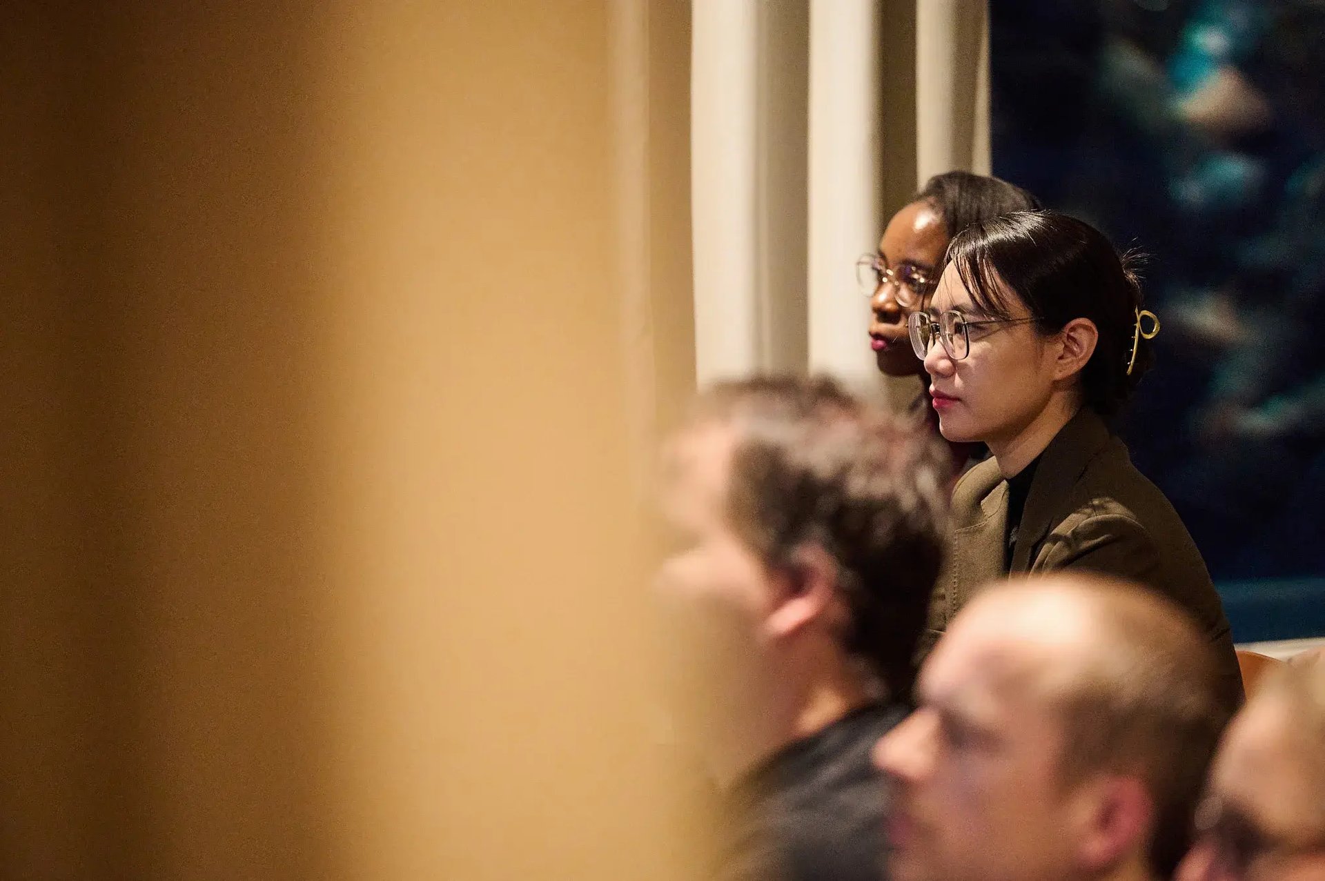 Pharmetheus consultants Dr. Kamunkhwala Gausi and Dr. Chun Liu listening attentively during a professional conference presentation